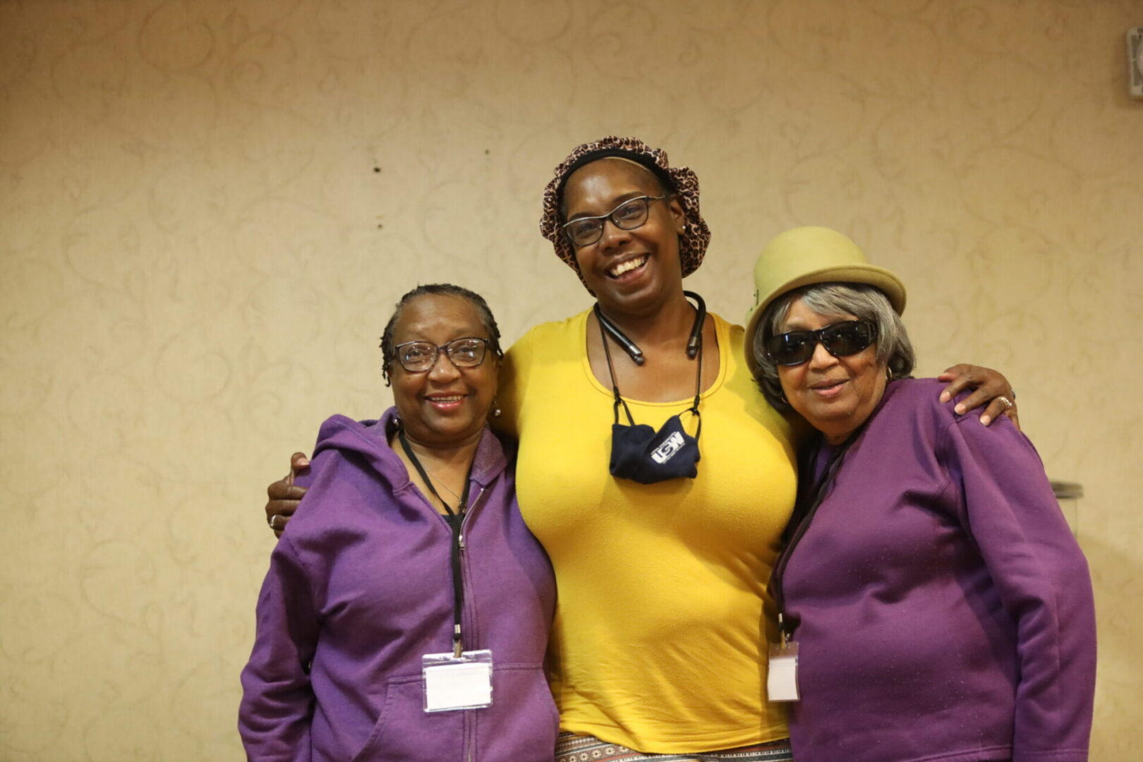 Group wearing purple and yellow outfits