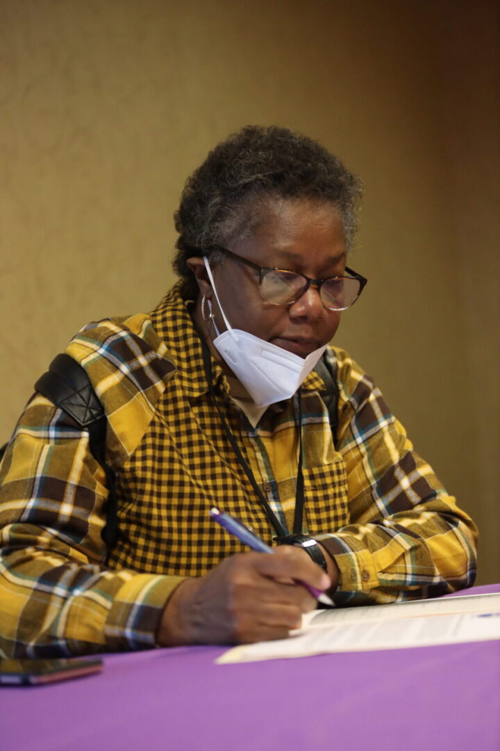 Person writing at a table
