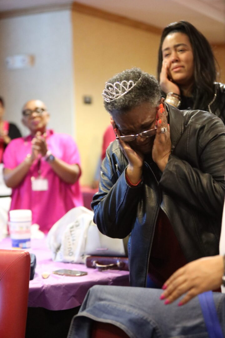 Emotional woman with tiara, people applauding